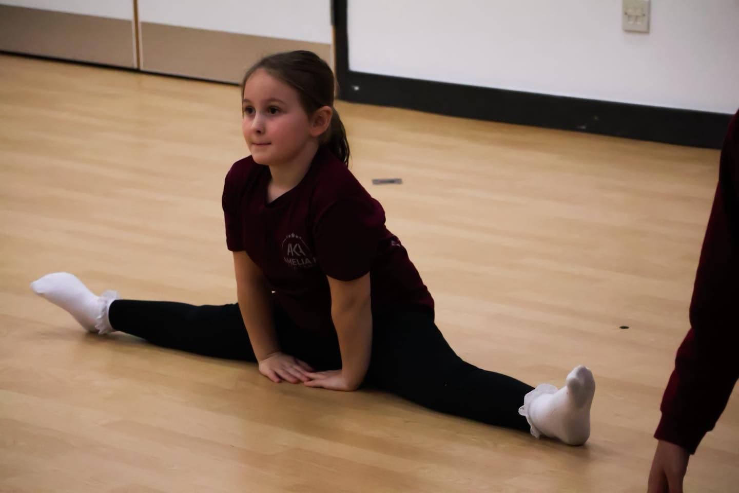 A pre-vocational student stretching in the studio