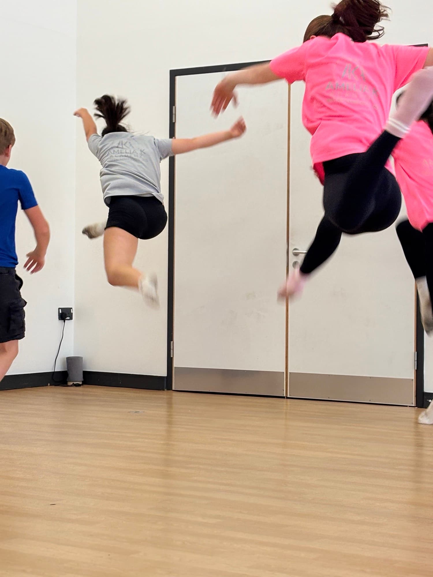 A line-up of Amelia K Academy students of different ages in the studio